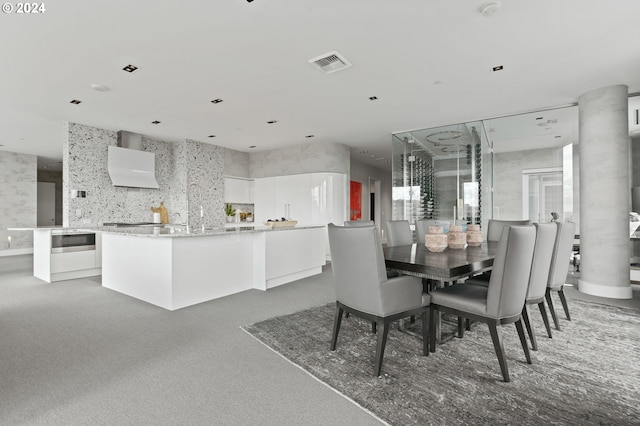 dining area featuring carpet and ornate columns