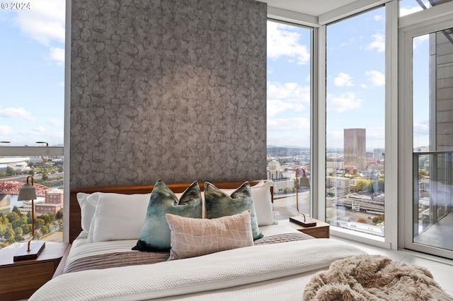 bedroom featuring a wall of windows and access to exterior