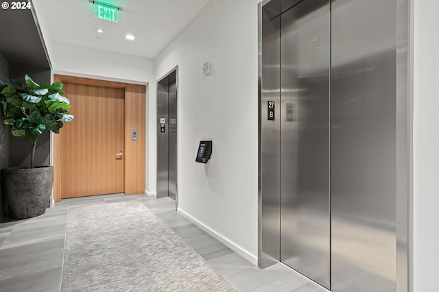 hallway featuring light hardwood / wood-style flooring and elevator