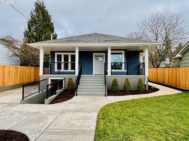 bungalow-style home with covered porch and a front yard