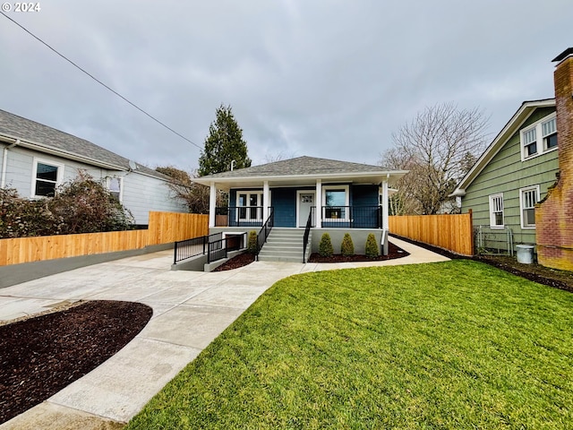 bungalow-style house with covered porch and a front lawn