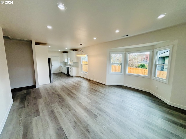 unfurnished living room with hardwood / wood-style floors