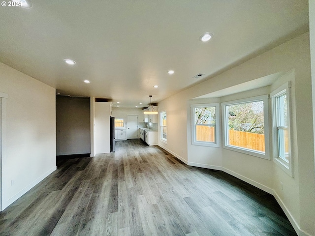 unfurnished living room featuring dark hardwood / wood-style flooring