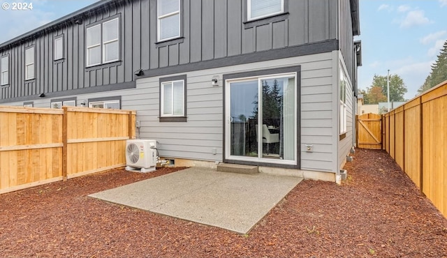 rear view of house with a patio and ac unit