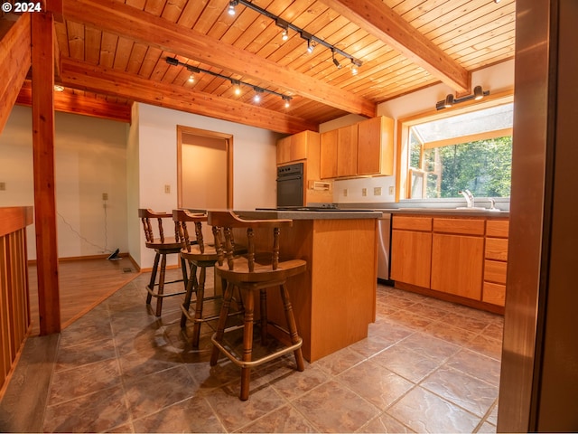 kitchen with beamed ceiling, oven, rail lighting, wooden ceiling, and tile patterned flooring