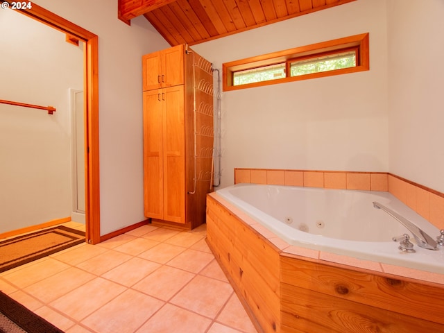 bathroom with wood ceiling, lofted ceiling, tile patterned flooring, and a relaxing tiled tub