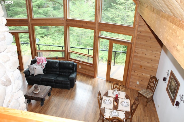 living room with wood walls and hardwood / wood-style floors