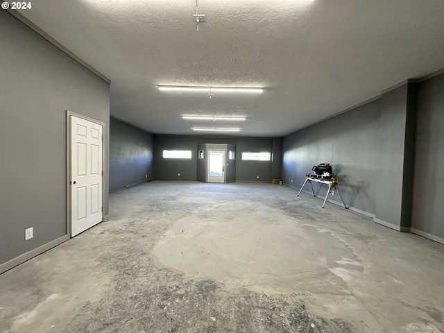 basement featuring a textured ceiling