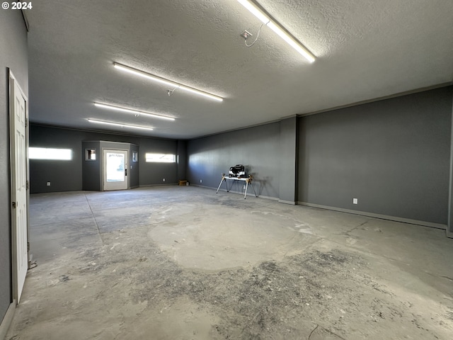 empty room featuring a textured ceiling and concrete flooring