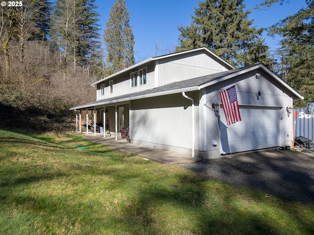 view of property exterior featuring a garage, a yard, and a shingled roof