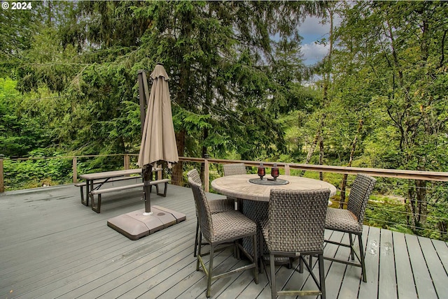 deck with outdoor dining area