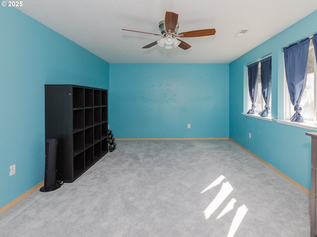 unfurnished bedroom with ceiling fan, carpet, visible vents, and baseboards