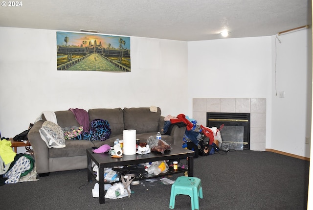 carpeted living room with a textured ceiling and a tile fireplace