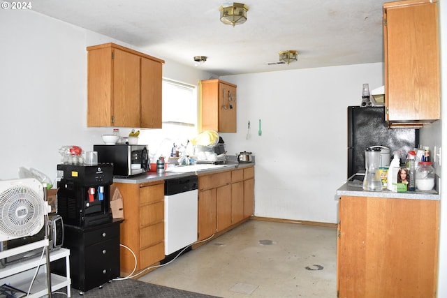 kitchen featuring black refrigerator and white dishwasher