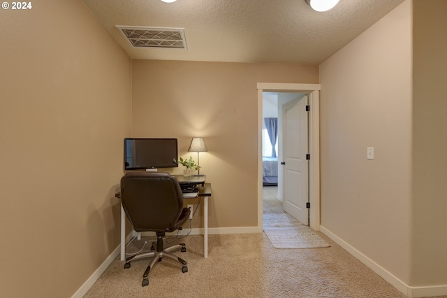 carpeted office featuring baseboards and visible vents