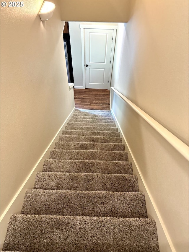 stairs with baseboards and wood finished floors