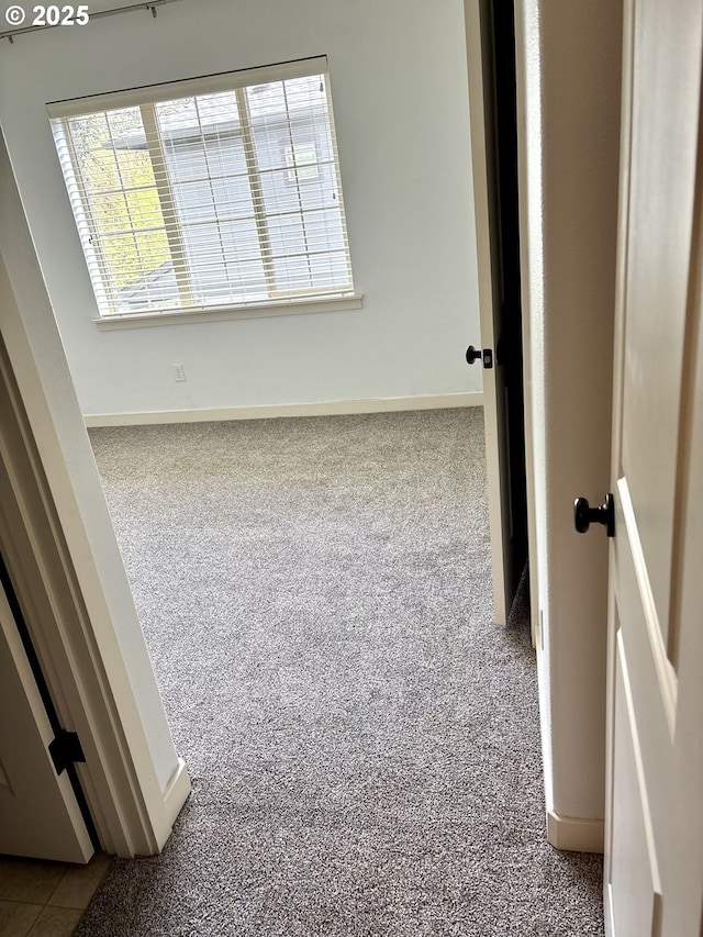 unfurnished room featuring baseboards