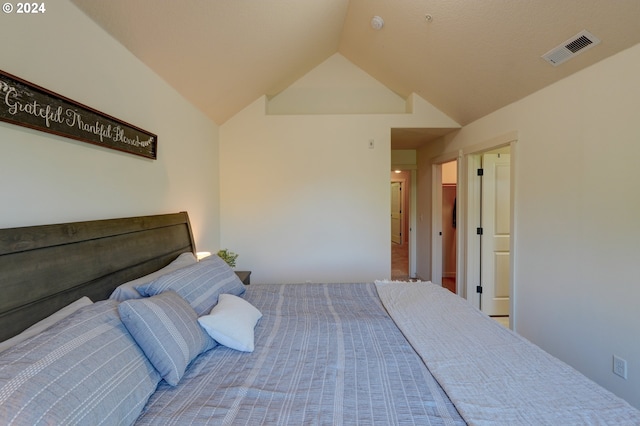 bedroom with lofted ceiling and visible vents
