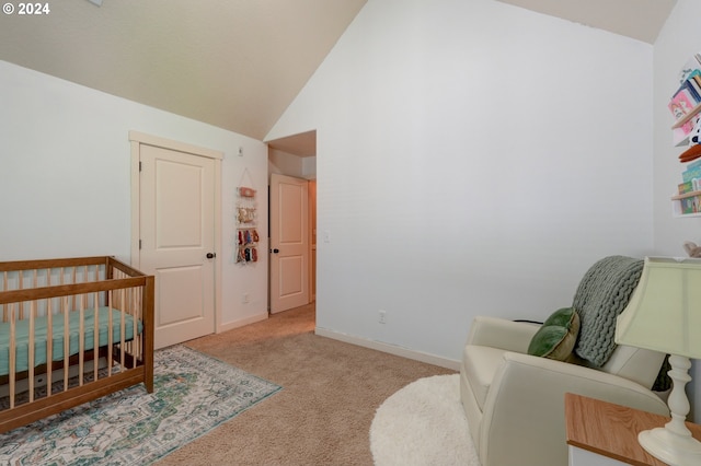 carpeted bedroom featuring lofted ceiling, baseboards, and a nursery area