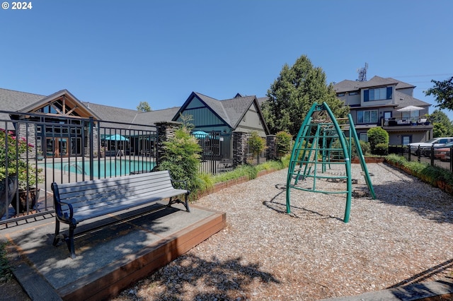 communal playground with fence and a fenced in pool