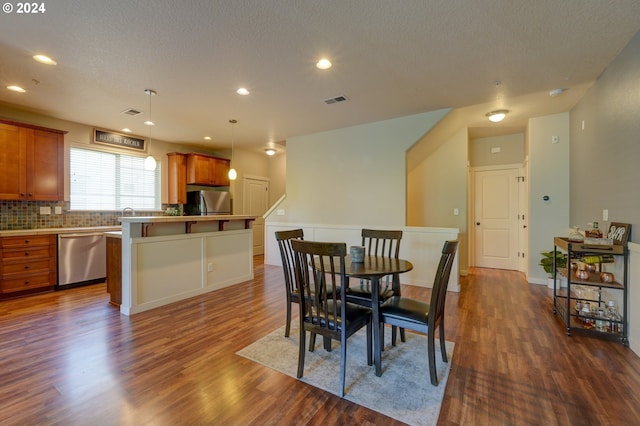 dining area featuring recessed lighting, a textured ceiling, visible vents, and dark wood-style floors