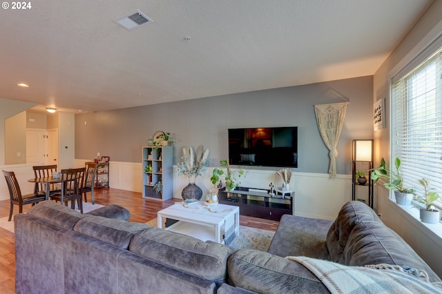 living room featuring wood finished floors and visible vents