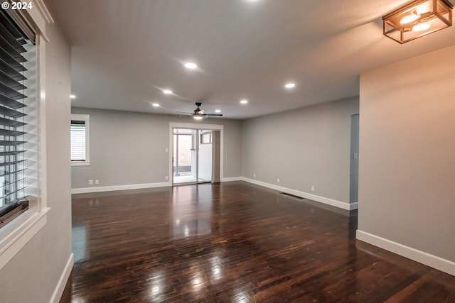 spare room with dark hardwood / wood-style floors and ceiling fan