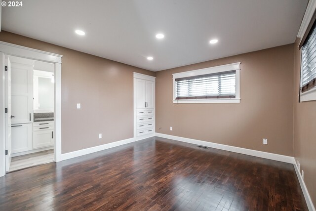 unfurnished bedroom featuring dark wood-type flooring