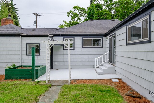 view of exterior entry with a yard