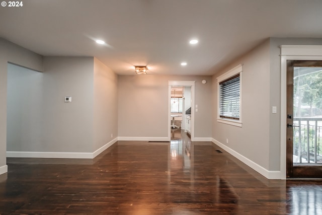 unfurnished room with dark hardwood / wood-style flooring