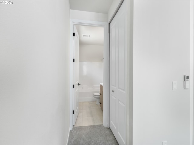 corridor featuring light tile patterned floors