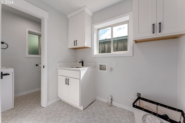 laundry area with sink, cabinets, and washer hookup