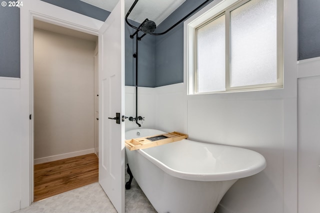 bathroom with a bath and tile patterned floors