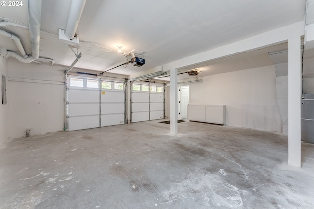 garage with electric panel and a garage door opener