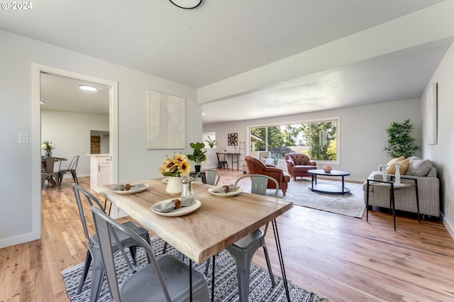 dining area with light hardwood / wood-style floors