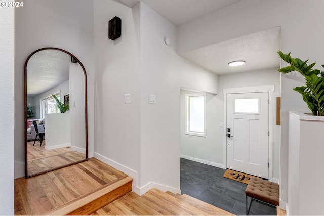 entryway featuring a textured ceiling and hardwood / wood-style flooring