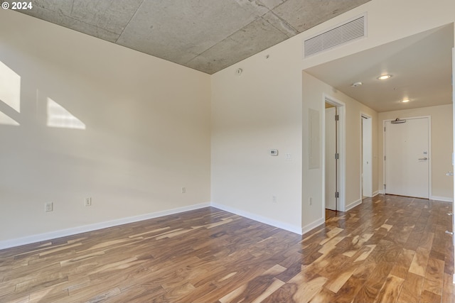 unfurnished room with hardwood / wood-style floors