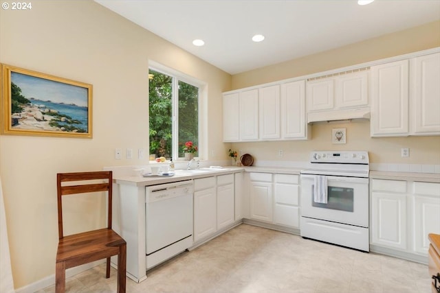 kitchen featuring white appliances, white cabinetry, and sink