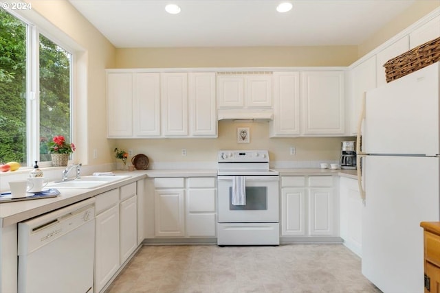 kitchen featuring white cabinets, white appliances, and sink