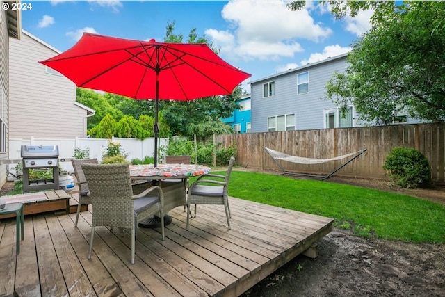 wooden terrace with area for grilling and a yard