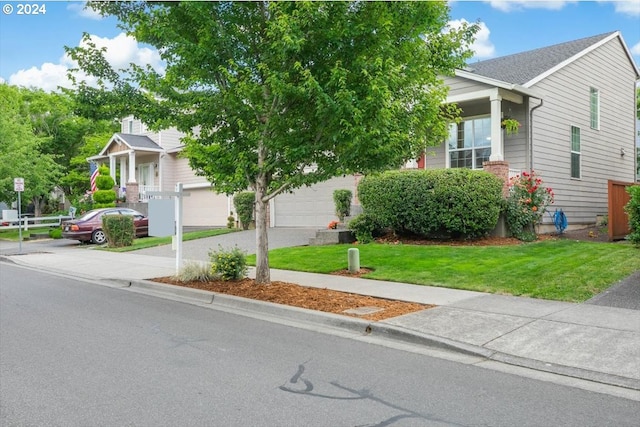 obstructed view of property with a garage and a front lawn