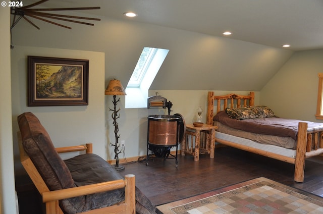 bedroom featuring dark hardwood / wood-style floors and lofted ceiling with skylight