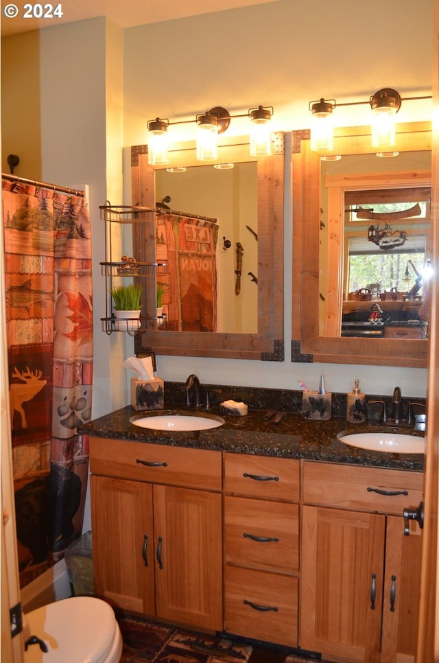 bathroom with vanity, toilet, and curtained shower