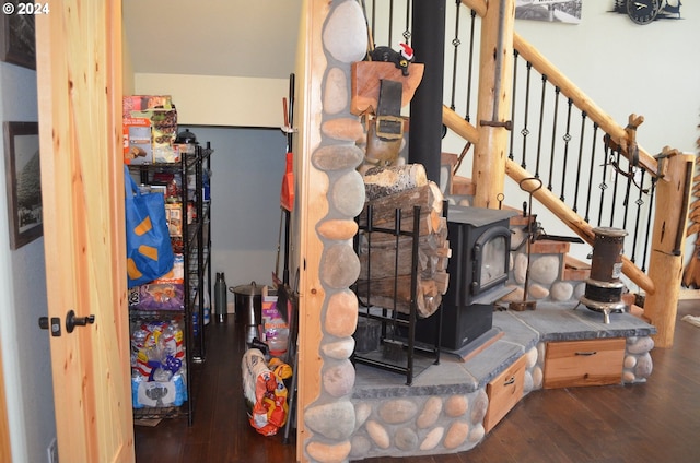 interior space with a wood stove and hardwood / wood-style flooring