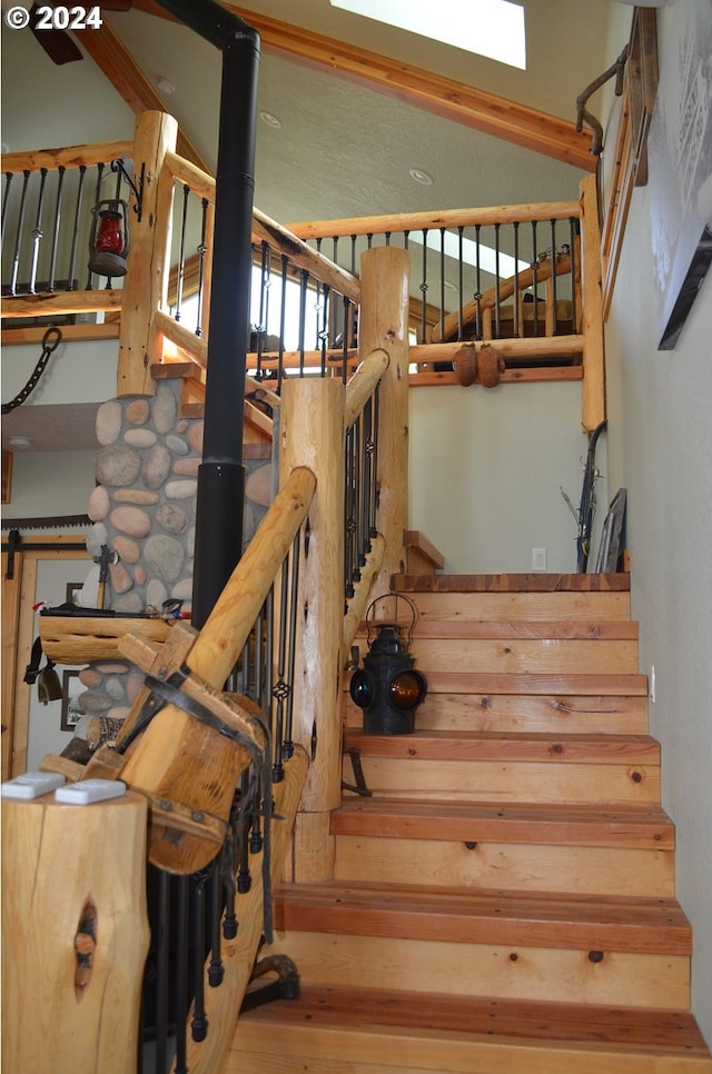 stairs with a wood stove and hardwood / wood-style flooring