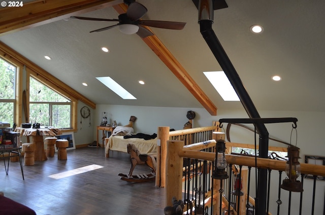 bonus room featuring ceiling fan, dark hardwood / wood-style floors, and lofted ceiling with skylight