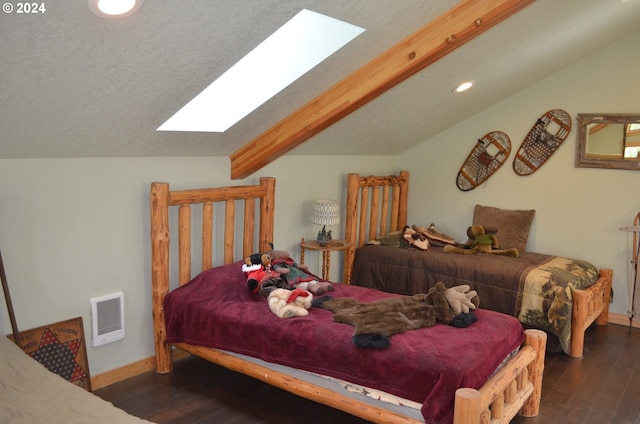 bedroom featuring dark hardwood / wood-style floors and lofted ceiling with skylight