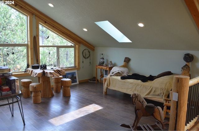 bedroom with dark wood-type flooring, multiple windows, and lofted ceiling with skylight