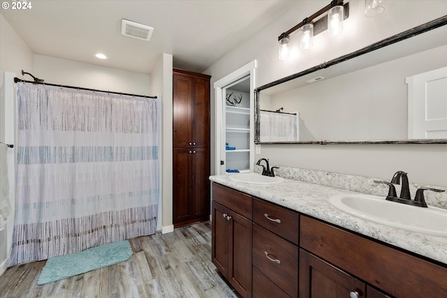 bathroom with hardwood / wood-style floors, vanity, and a shower with shower curtain