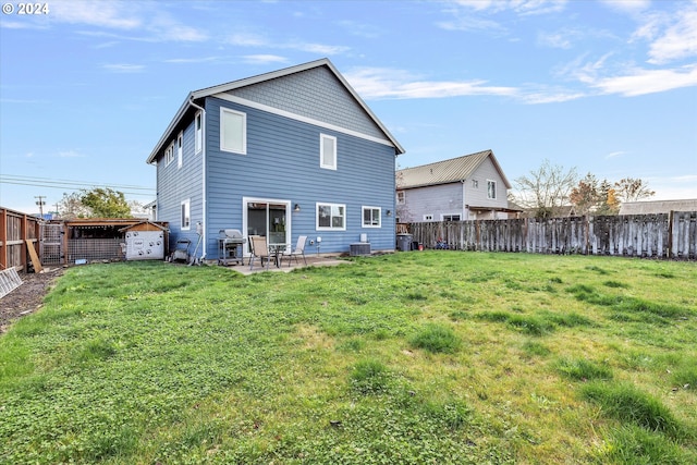 back of property with a lawn and a patio area